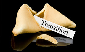 A broken fortune cookie with a slip of paper that reads "Transition".